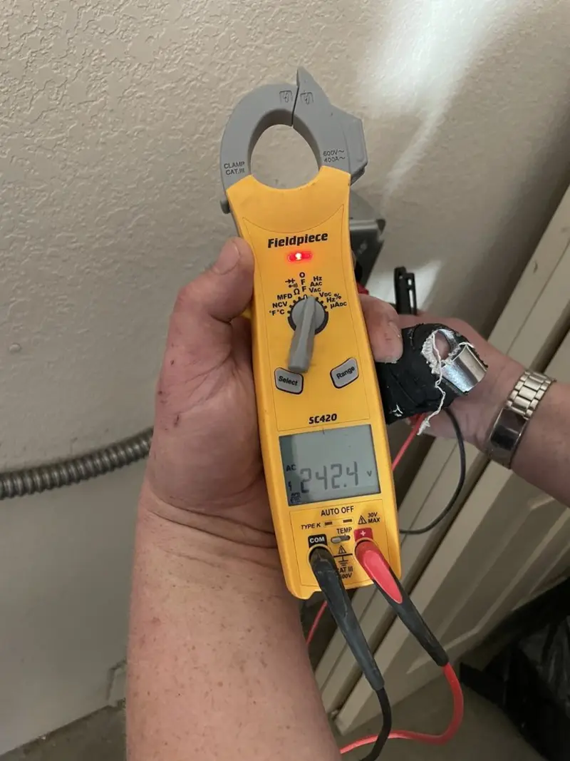 Voltage testing with clamp meter during Outlet Installation in Kyle
